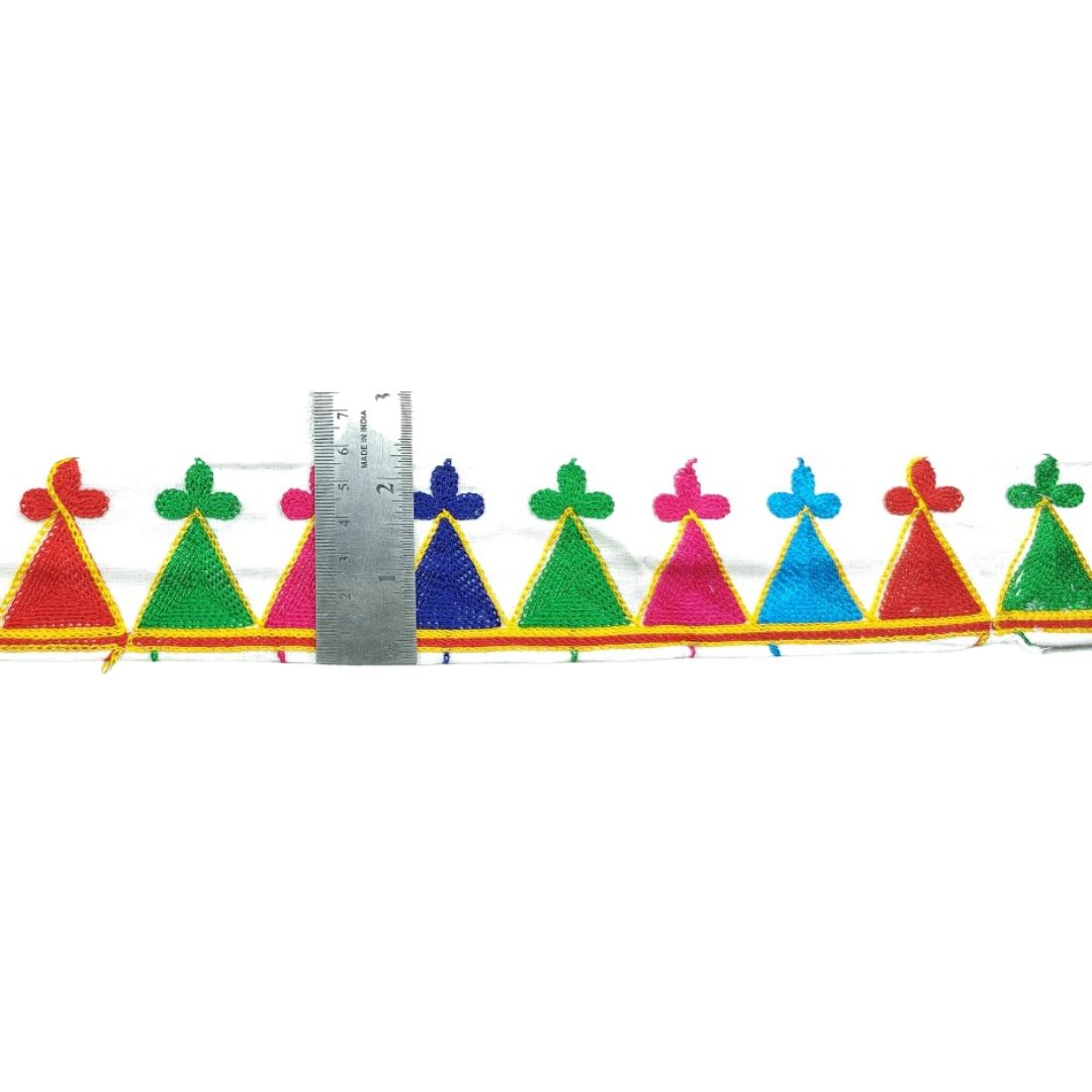 Colorful triangular patterns with a ruler for scale on a white background